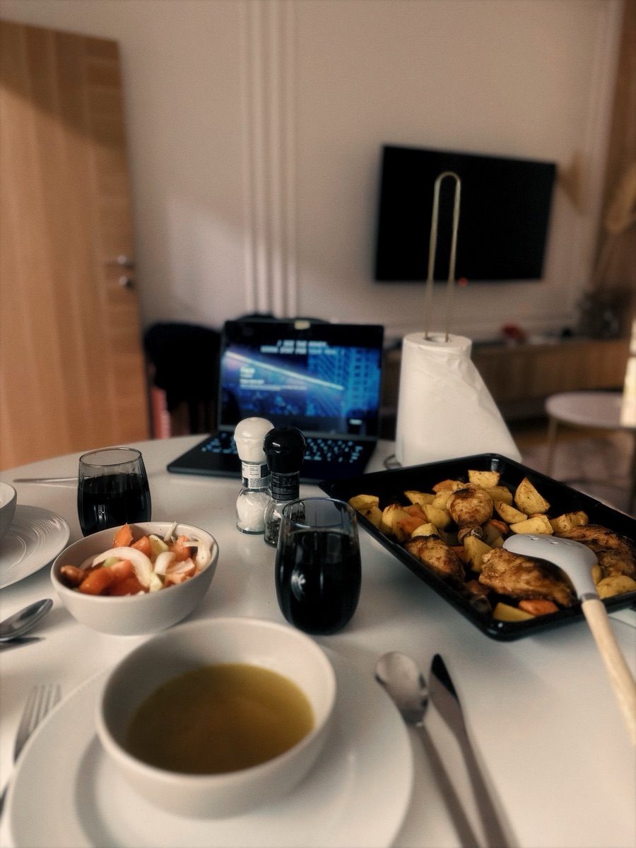 Dinner on the table: roast chicken and potatoes, soup and a tomato salad